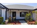Inviting front porch with detailed door and manicured landscaping around the entry at 1060 Still Rd, Pierson, FL 32180