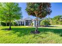 Lush front lawn and mature landscaping frame this beautiful residence, creating a welcoming ambiance at 1404 Newry Cir, Ormond Beach, FL 32174