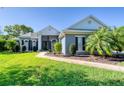 Charming home featuring a lush green lawn and mature landscaping for enhanced curb appeal at 1404 Newry Cir, Ormond Beach, FL 32174