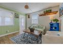 Cozy living room featuring wood floors, a patterned rug, and bright green walls at 151 Holland Rd, Ormond Beach, FL 32176