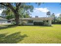 Well-maintained single-story home with tidy landscaping and a spacious green lawn at 2120 Queen Palm Dr, Edgewater, FL 32141