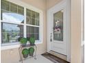 Inviting entryway featuring a white front door, sidelight window, and decorative plants at 3205 Bailey Ann Dr, Ormond Beach, FL 32174