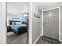 Cozy bedroom with coastal decor, wood-look flooring, and a comfortable queen-sized bed at 3370 Ocean Shore Blvd # 206B, Ormond Beach, FL 32176