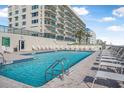 Relax by the sparkling outdoor pool with comfortable lounge chairs, with access to the beach at 4631 S Atlantic Ave # 8706, Ponce Inlet, FL 32127