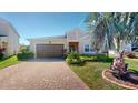 Charming single-story home with brick driveway, well-manicured landscaping and attached two-car garage at 5431 Hutchinson St, Port Orange, FL 32128