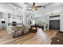 Inviting living room featuring hardwood floors, a tray ceiling, and an open floor plan at 6809 Plumpjack Ct, Port Orange, FL 32128