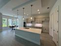 Spacious kitchen with a large center island, modern lighting, and an adjacent dining area at 1665 Lake Reserve Dr, Deland, FL 32724