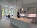 Modern kitchen with quartz countertops, stainless steel appliances, and stylish pendant lighting at 1665 Lake Reserve Dr, Deland, FL 32724