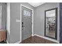 Welcoming entryway features a stylish gray front door with decorative glass and a full length mirror at 1836 Biscayne Ave, South Daytona, FL 32119