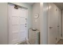 Inviting entryway with storage cabinet and coastal decor, leading into a beautifully designed condo at 1155 Ocean Shore Blvd # 702, Ormond Beach, FL 32176