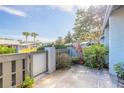 Townhome courtyard with a mix of lush landscaping, including shrubs and potted plants at 140 Limewood Pl # 2, Ormond Beach, FL 32174