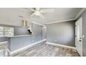 Open-concept living space with marble-look flooring and neutral gray walls at 330 Ponce Deleon Blvd, De Leon Springs, FL 32130