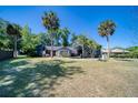 Charming two-story home featuring lush lawn, mature trees, and blue siding in a picturesque neighborhood at 330 Wall Ave, Ormond Beach, FL 32174