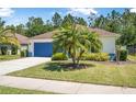 Beautifully landscaped front yard with healthy green lawn and vibrant landscaping surrounding a well-maintained one-story home at 43 Pergola Pl, Ormond Beach, FL 32174
