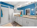 Bathroom featuring a double sink vanity with granite countertops and a glass-enclosed shower at 5635 Estero Loop, Port Orange, FL 32128