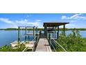 A private boat lift and dock offer direct water access and feature a covered area for vessel protection at 5809 Riverside Dr, Port Orange, FL 32127