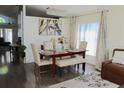 Elegant dining area with seating for six, decorative chandelier and artwork, and natural light at 8958 Fort Jefferson Blvd, Orlando, FL 32822