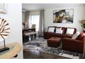 Inviting living room featuring a comfortable leather sofa and stylish decor, adjacent to a dining area at 8958 Fort Jefferson Blvd, Orlando, FL 32822