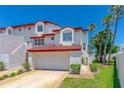 Charming townhome featuring red-tiled roof, two-car garage and a well-maintained yard at 200 Florida Shores Blvd, Daytona Beach, FL 32118