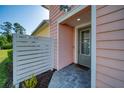 Inviting front entrance with gray door, brick pavers, and decorative wood screen for added privacy at 324 Coral Reef Way, Daytona Beach, FL 32124
