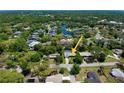 Aerial shot showcasing the property, lush greenery, nearby lake, and the peaceful neighborhood at 75 Knollwood Estates Dr, Ormond Beach, FL 32174