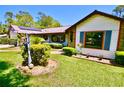 Charming single Gathering home featuring lovely front yard with green grass and tasteful landscaping at 75 Knollwood Estates Dr, Ormond Beach, FL 32174