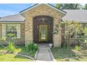 Inviting front entrance with a brick archway and a glass-paneled door at 4008 Acoma Dr, Ormond Beach, FL 32174