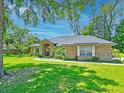 Beautiful one story home with mature trees and a green lawn in a serene setting at 4008 Acoma Dr, Ormond Beach, FL 32174