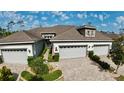 Aerial view of the home featuring its landscaping, driveway, and a glimpse of the surrounding community at 745 Aldenham Ln, Ormond Beach, FL 32174
