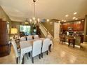 A spacious and naturally lit living room with dining area flowing into the kitchen, perfect for entertaining at 745 Aldenham Ln, Ormond Beach, FL 32174