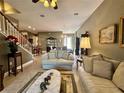 Inviting living room featuring tile floors, plush seating, and elegant decor at 745 Aldenham Ln, Ormond Beach, FL 32174