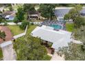 Aerial shot showcases a home with a screened-in pool, lush backyard, and proximity to neighboring residences at 11 Larisa Ter, Ormond Beach, FL 32174