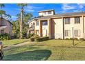 Charming townhome featuring a well-kept lawn and a walkway leading to the front door at 133 Blue Heron Dr # C, Daytona Beach, FL 32119