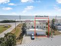 Coastal home featuring a Spanish tile roof, inviting facade, and scenic ocean backdrop at 3074 Ocean Shore Blvd, Ormond Beach, FL 32176