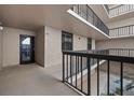 Condo hallway featuring dark trim and neutral-toned walls, leading to unit door at 3370 Ocean Shore Blvd # 205-B, Ormond Beach, FL 32176