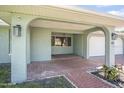 Inviting covered front porch with brick pavers and arched entryways at 44 Sandra Dr, Ormond Beach, FL 32176