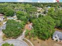 Aerial view of a lush, tree-lined neighborhood showing a home with a brown roof at 440 Champagne Cir, Port Orange, FL 32127