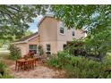Cozy backyard patio featuring an outdoor dining set surrounded by lush plants and greenery at 440 Champagne Cir, Port Orange, FL 32127