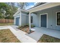 Single-story home featuring a front-facing garage, covered porch, and modern landscaping at 5620 Ridgewood Ave, De Leon Springs, FL 32130