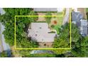 Aerial view of a single-story home surrounded by mature landscaping and adjacent to a natural waterway at 912 Fruitwood Pl, Port Orange, FL 32127