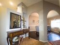 Inviting foyer with decorative console table, arched doorways leading to dining room, and neutral paint at 10031 Sw 62Nd Cir, Ocala, FL 34476