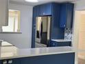 Kitchen with stainless steel refrigerator and custom cabinets with nautical hardware at 127 Mason Park Dr, Daytona Beach, FL 32117