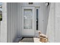 Close-up of the front door with a decorative dog statue and welcome mat at 129 Golden Eye Dr # C, Daytona Beach, FL 32119