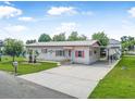 Lovely single-story home featuring a brick facade, tidy lawn, and convenient covered parking area at 24538 Wildhog Rd, Astor, FL 32102