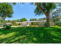 Well-maintained single-story home with a spacious front lawn and mature trees at 3119 Mango Tree Dr, Edgewater, FL 32141
