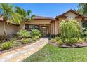 Inviting front entrance with a stone pathway and lush landscaping leading to the front door at 3513 Kilgallen Ct, Ormond Beach, FL 32174
