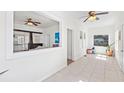 Sunroom with white walls and ceramic tile overlooking living room and fireplace at 509 Park Dr, Daytona Beach, FL 32114