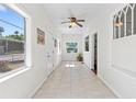 Bright sunroom boasts tile floors, large windows, and a ceiling fan, creating a relaxing atmosphere at 509 Park Dr, Daytona Beach, FL 32114
