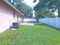 Large backyard with a sparkling pool and privacy fence at 601 E Tall Pine Ter, Deland, FL 32724
