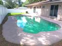 Private backyard pool with ample concrete patio space for outdoor lounging at 601 E Tall Pine Ter, Deland, FL 32724